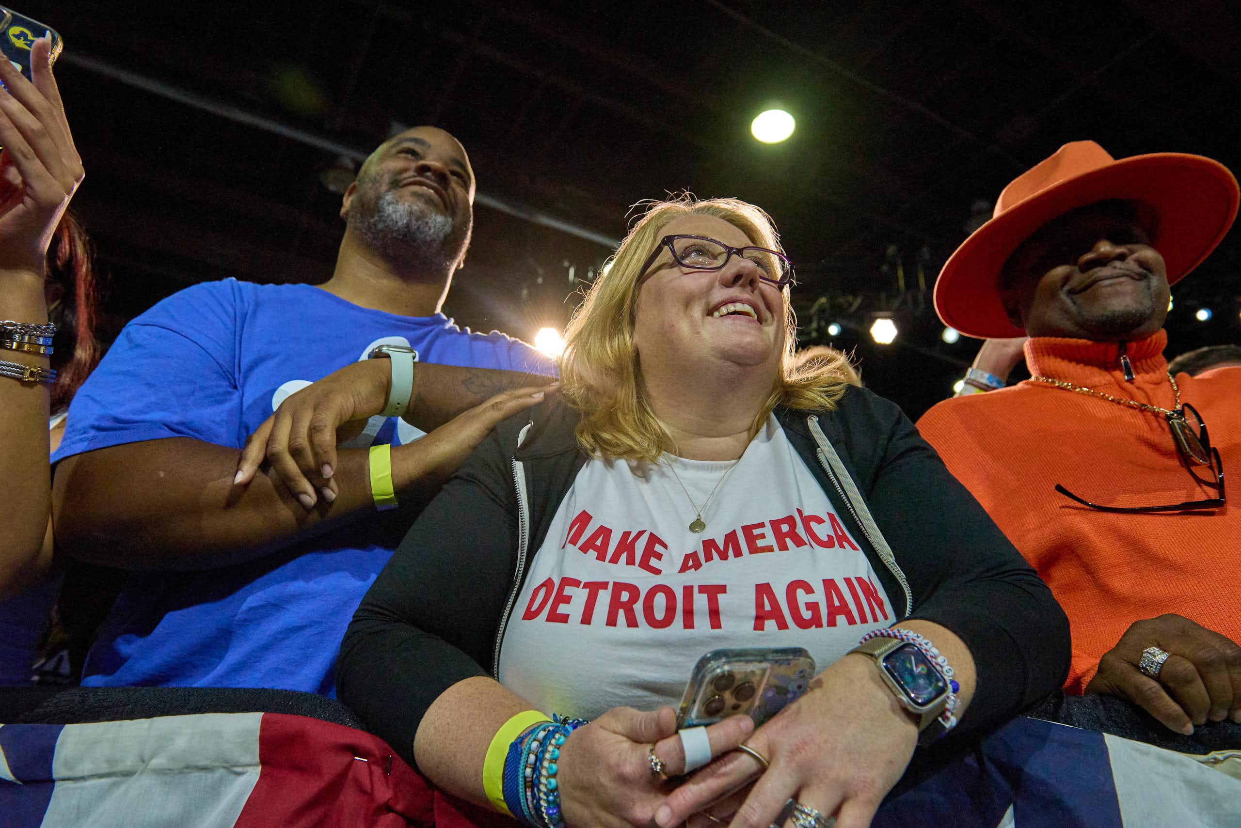 A smiling woman wears a T-shirt reading "Make America Detroit Again"