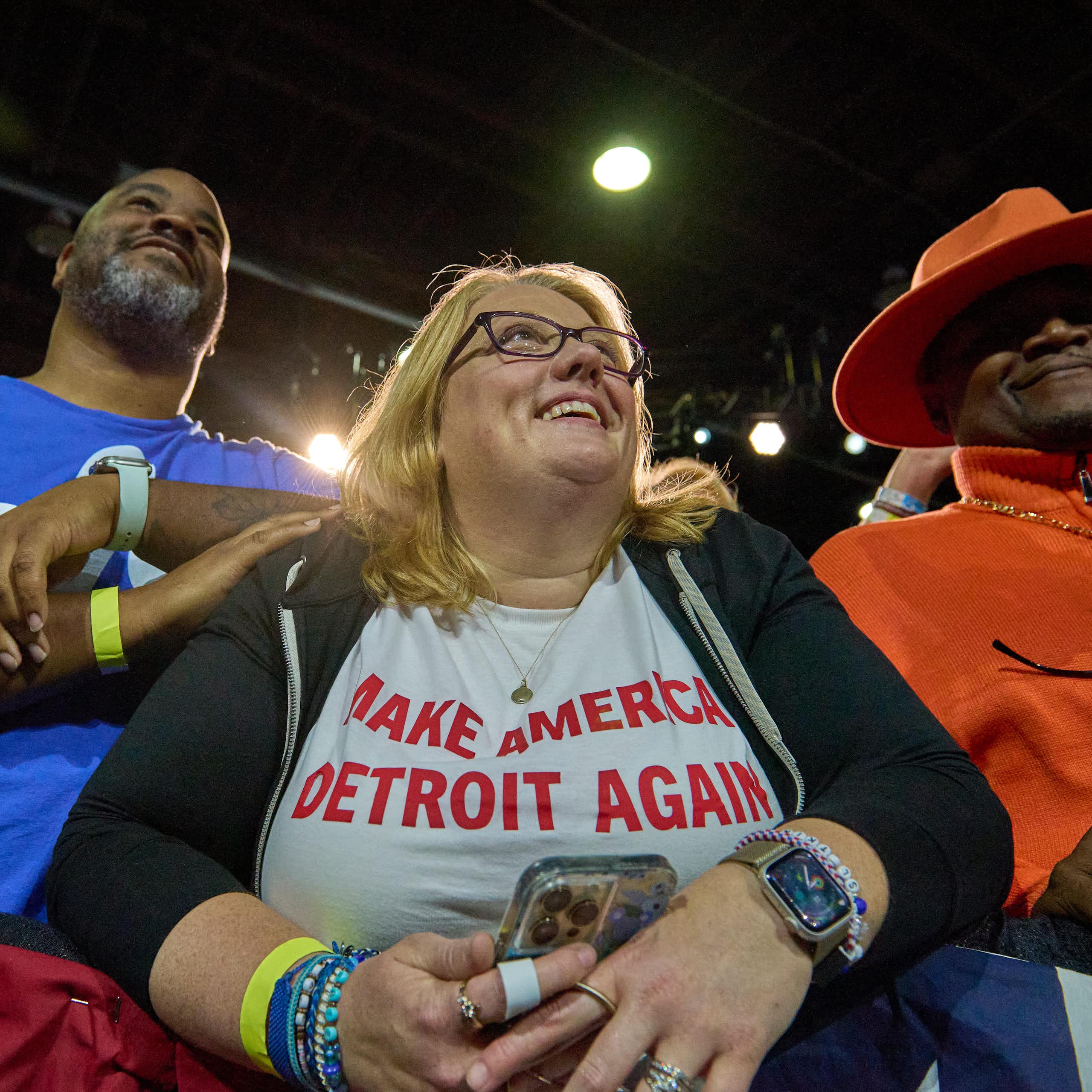 A smiling woman wears a T-shirt reading "Make America Detroit Again"