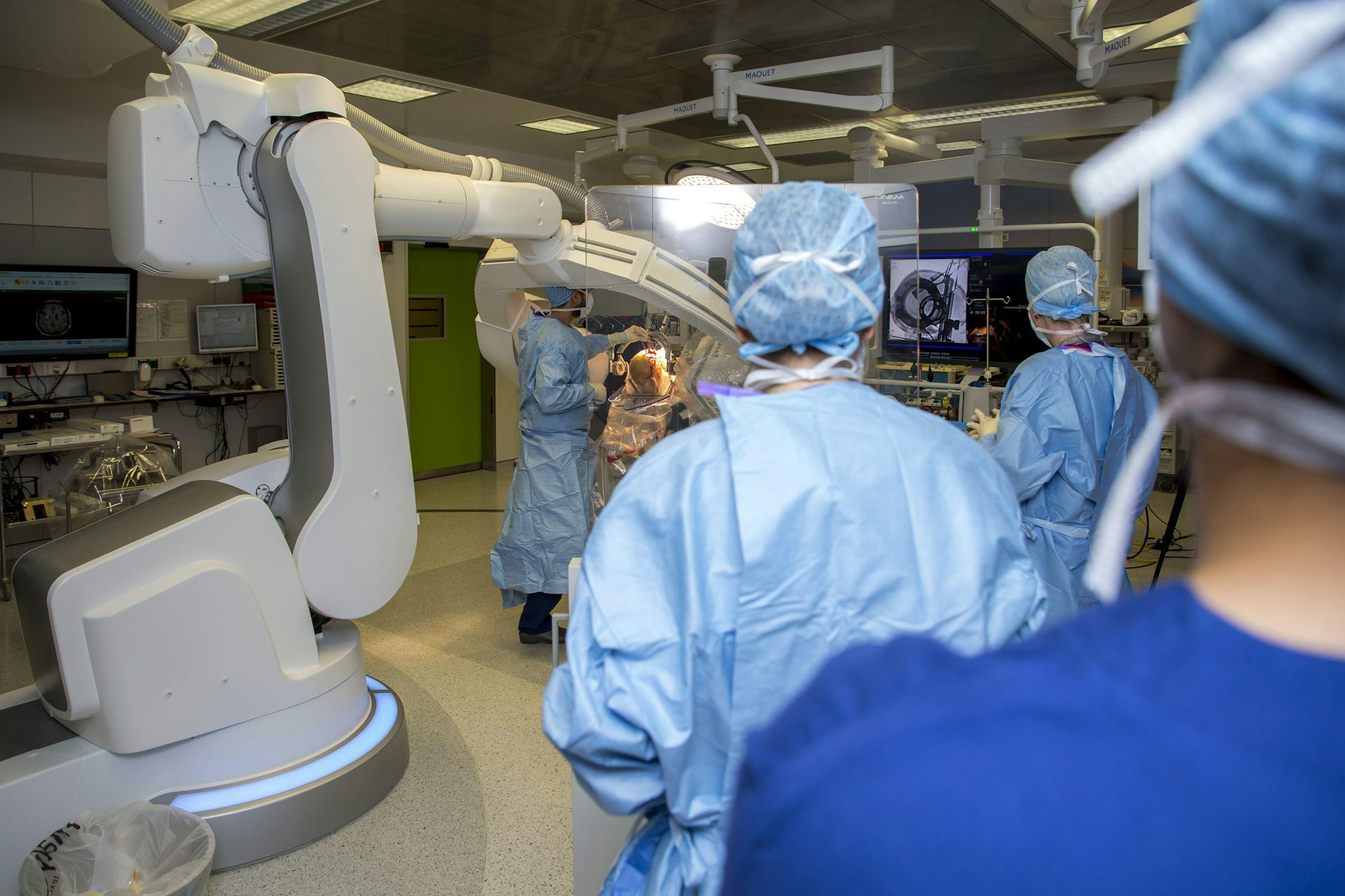 An operating theatre full of medical staff.