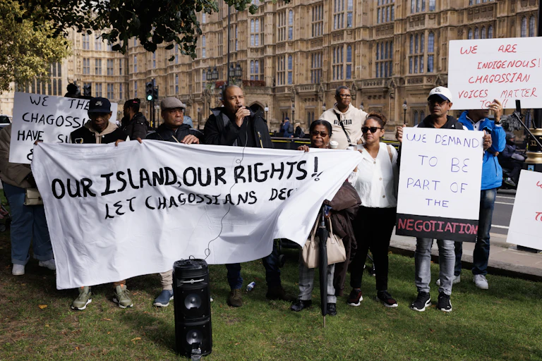 A group of people holding placards and banners in protest