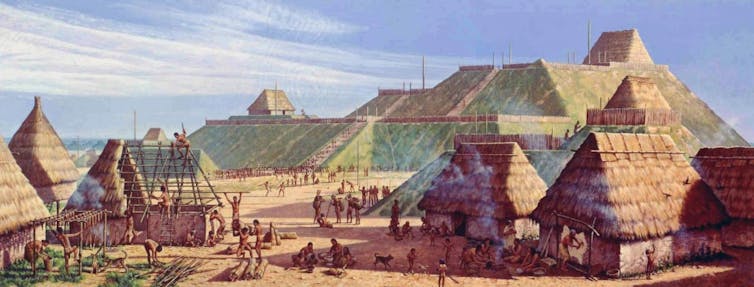 A painting shows people erecting wooden and thatch buildings against a backdrop of massive flat-topped mounds.