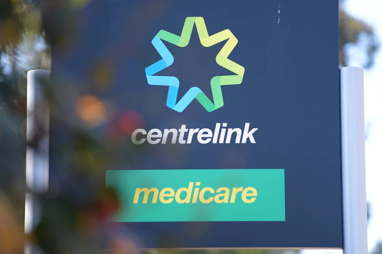 A black sign with the centrelink and medicare logos