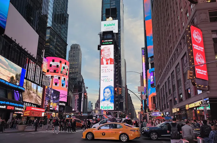 A billboard in Times Square showing odds that favour Trump to win the election by 51% to 49%.