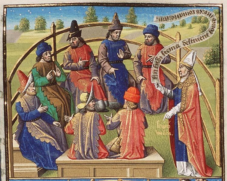 A colorful illustration of men in red, blue and green robes and pointy hats sitting inside a fenced-off area and talking.