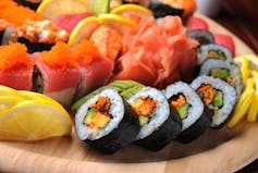 sushi on a plate, colourful with orange salmon fish
