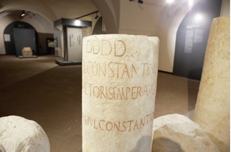 A milestone shows the spot where Crispus' name has been rubbed out.