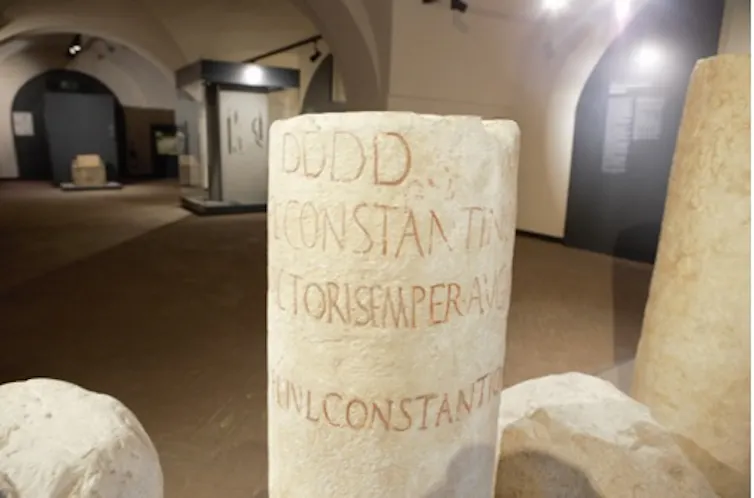 A milestone shows the spot where Crispus' name has been rubbed out.