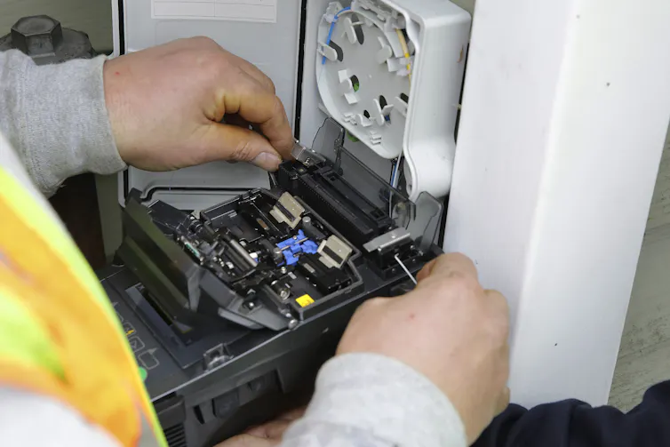 closeup of man installing an internet connection