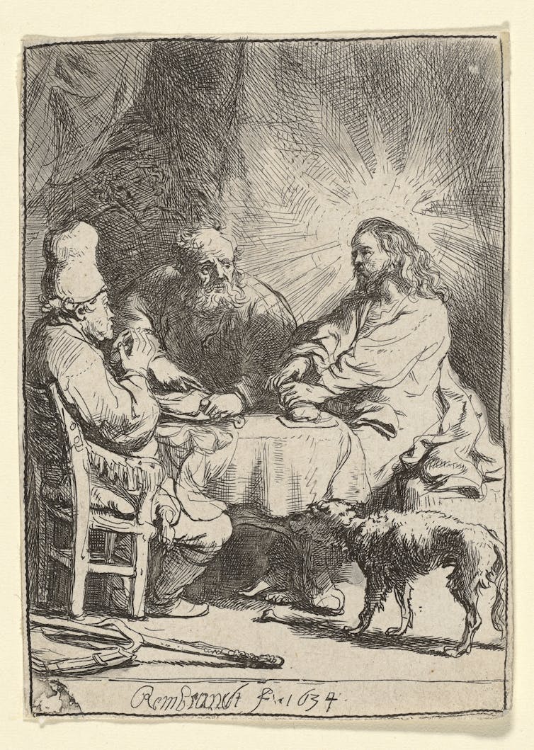Three men at a table, a dog looks on.