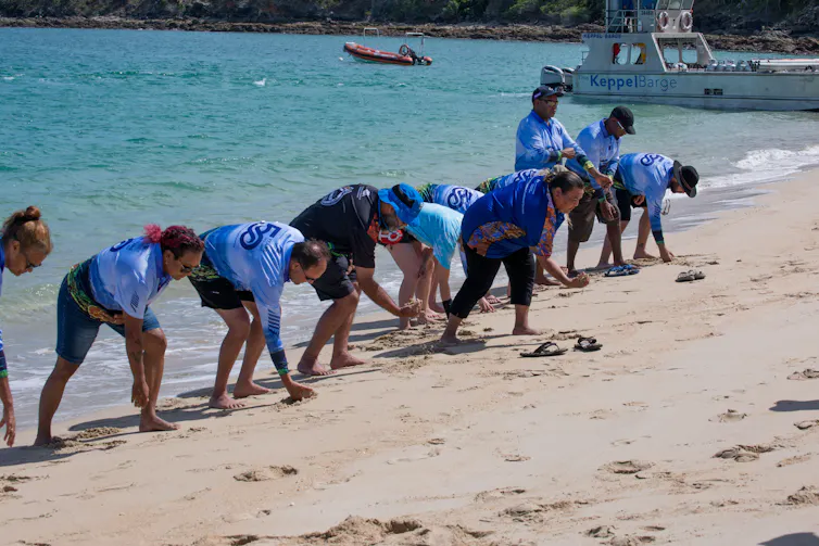 Traditional owners and scientists work together on gathering coral spawn.