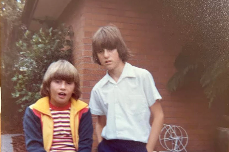 Two boys in the 1970s in a suburban backyard.