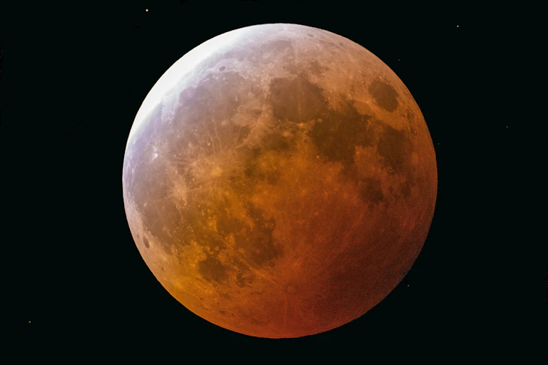 A photo of the Moon looking reddish.