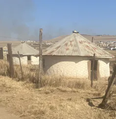 Round buildings with metal sheet roofs.