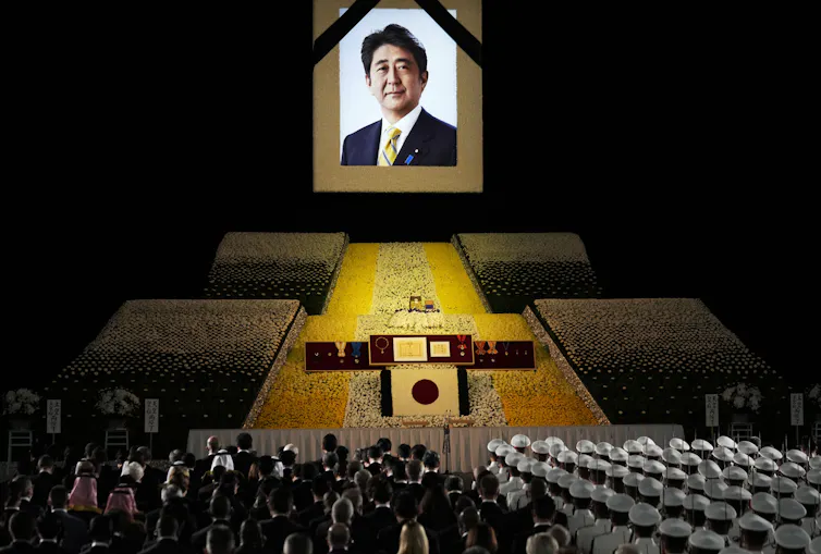 A portrait of Shinzo Abe hangs on the stage during his state funeral.