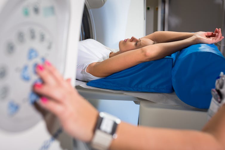 female patient going into an CAT scanner