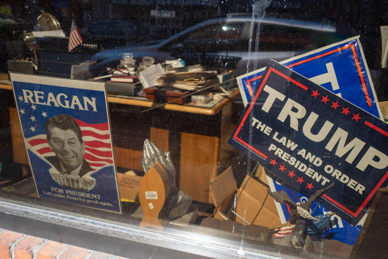 Signs showing Ronald Reagan and Donald Trump.