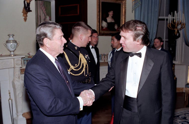Ronald Reagan shaking hands with Donald Trump in 1987.