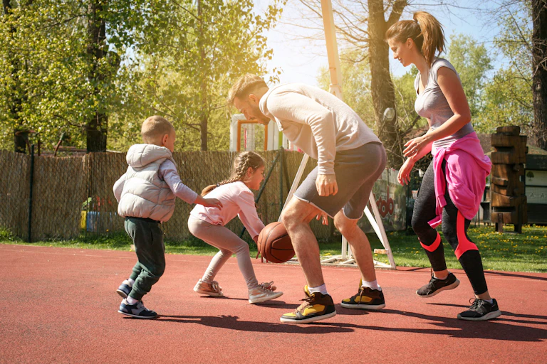 A family of four plays basketball