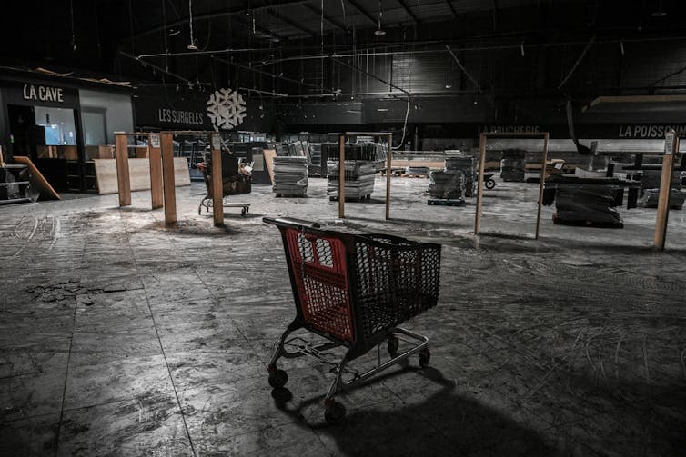 An empty shopping cart inside a large room
