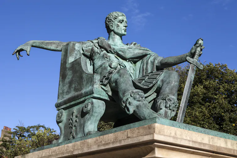 A statue of Constantine is set against a blue sky.