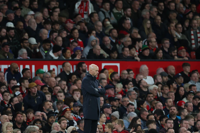 Ten Hag and supporters watching a match.
