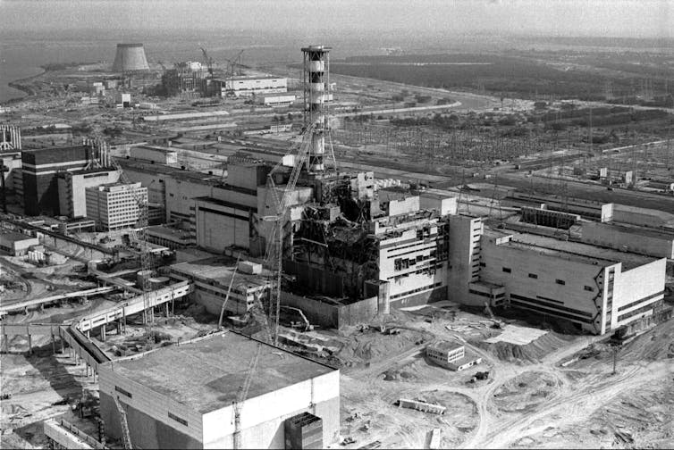 A black and white photo of the damaged Chernobyl power station.