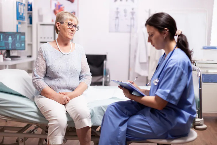 Clinician confers with patient