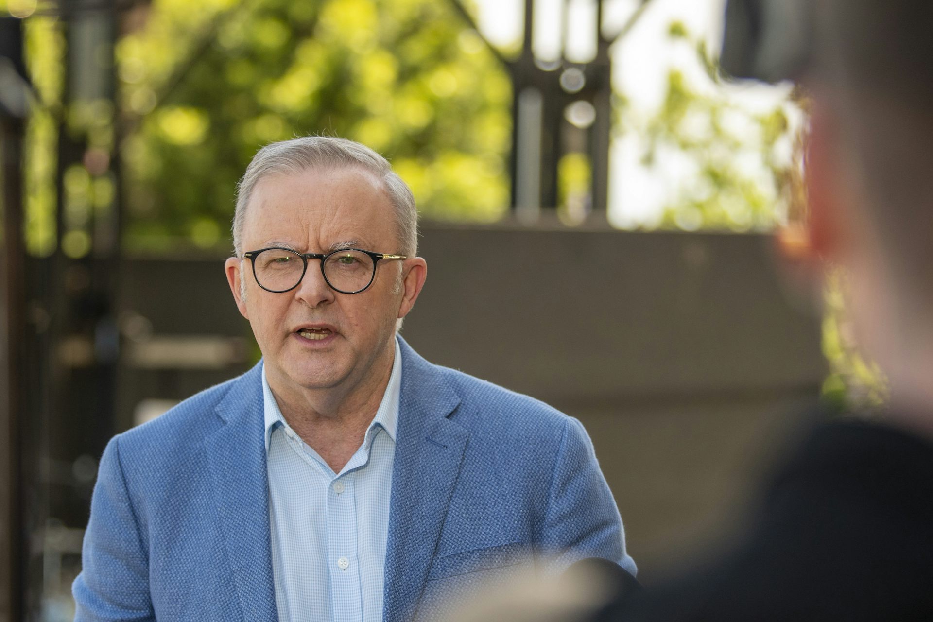 Prime Minister Anthony Albanese speaks to reporters outside.