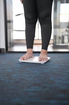 Feet standing on electric scales.