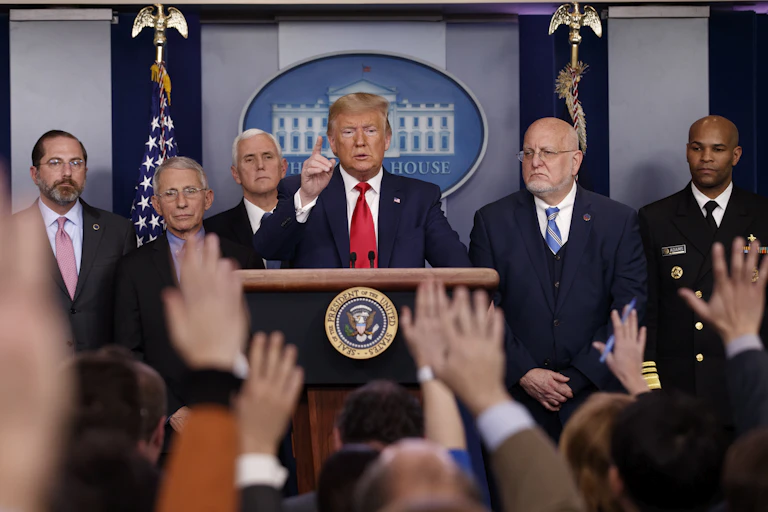 Donald Trump at a podium flanked by five other men