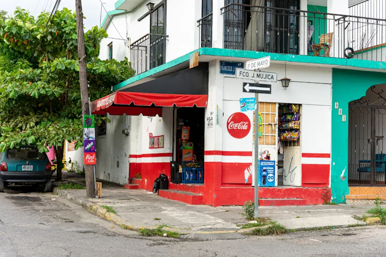 Corner shop in Mexico, featuring a Coca-Cola advert.