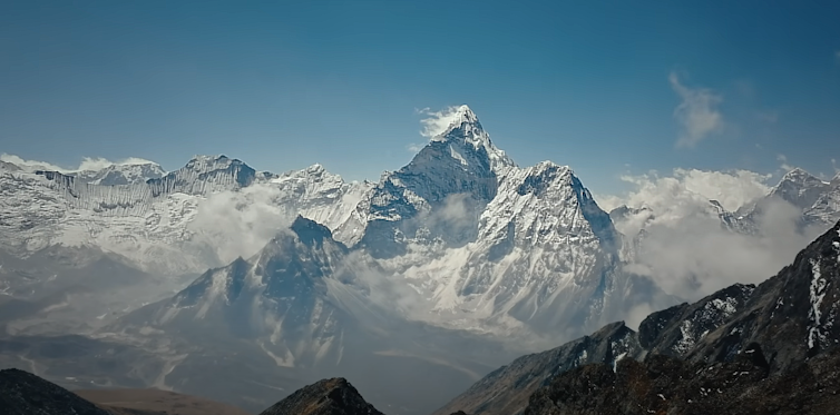 A very high mountain with a snow-capped peak