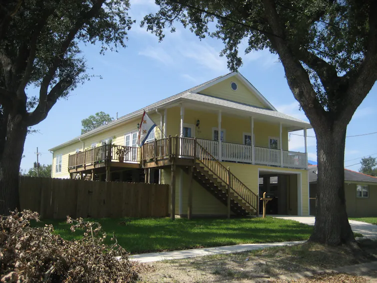 A new home - essentially a single-story home but raised about 14 feet above ground level with a garage below.