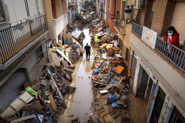 man walking flooded street spain