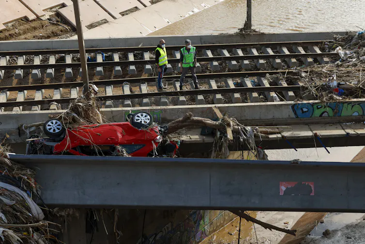 workers inspecting flood damaged railway