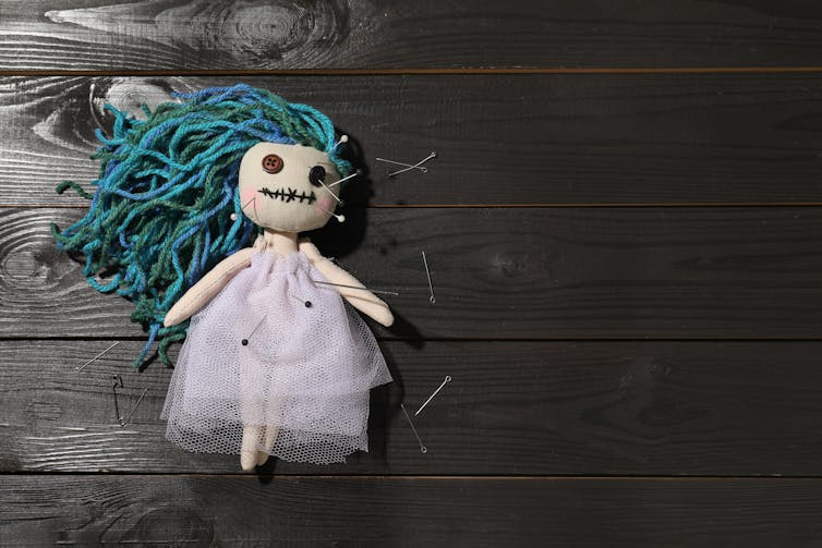 cloth doll with pins in it