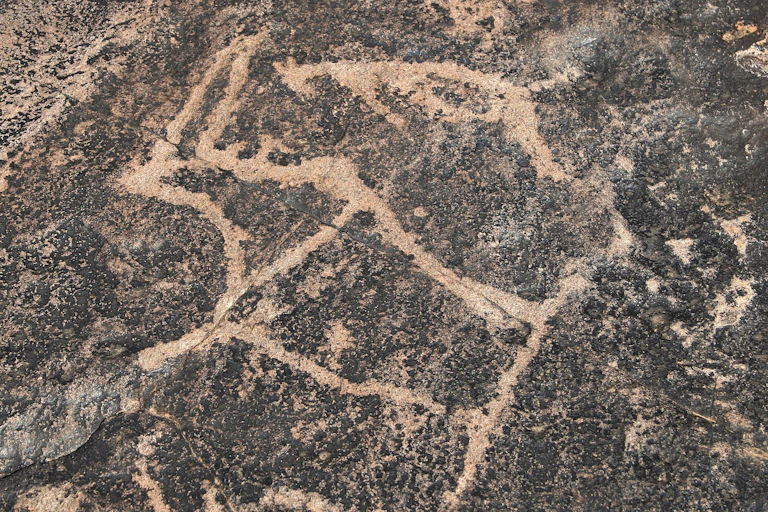 Engraving of figures on a rock face