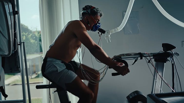A man rides a stationary bike