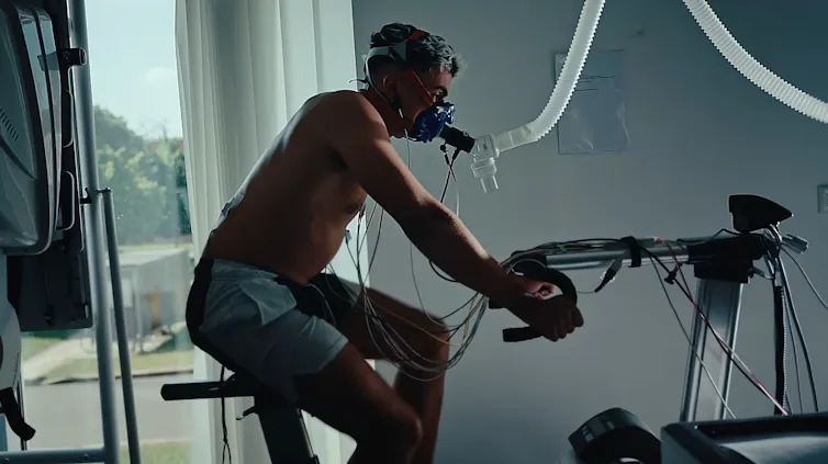A man rides a stationary bike