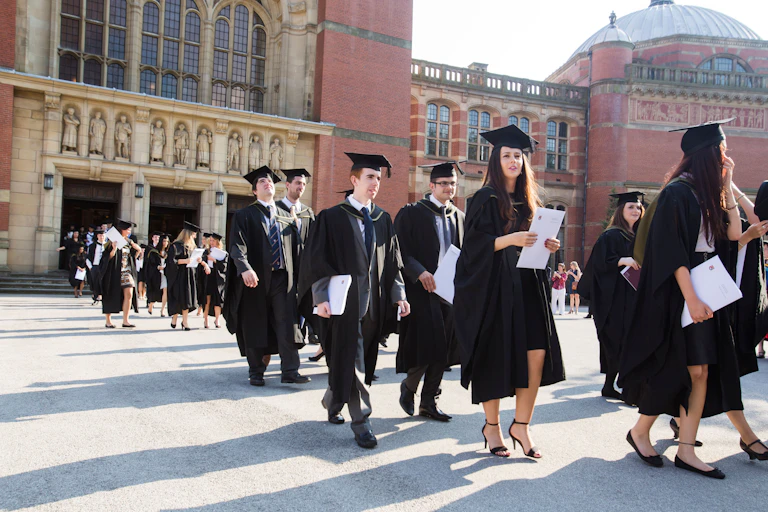 Graduates leaving the Great Hall at Birmingham University, UK, after the graduation ceremony.
