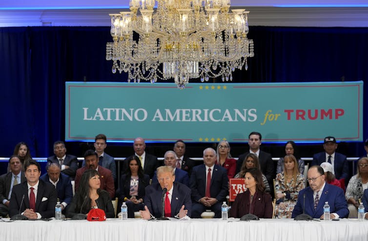 President Donald Trump, front centre, participates in a roundtable with Latino leaders