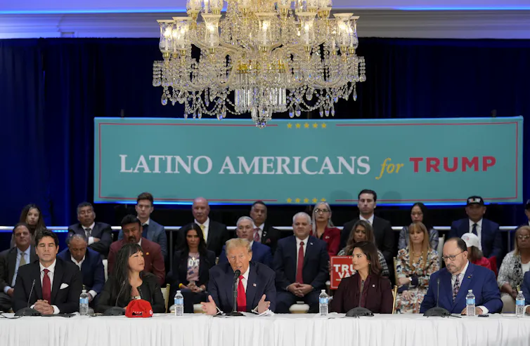 President Donald Trump, front centre, participates in a roundtable with Latino leaders