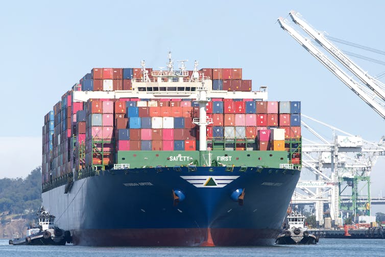 A large cargo ship docked at the Port of Oakland in California