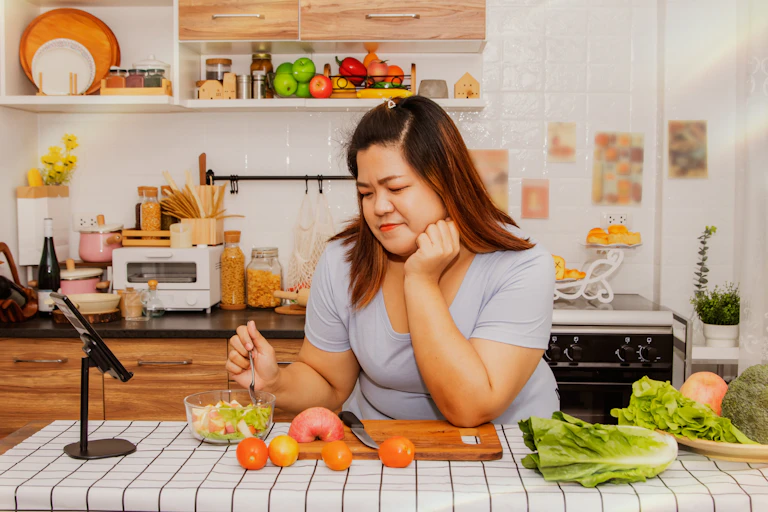 Woman looks at salad