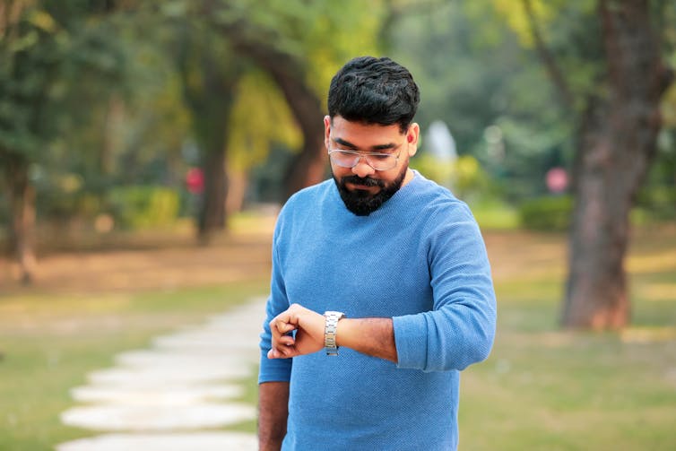 Man looks at his watch