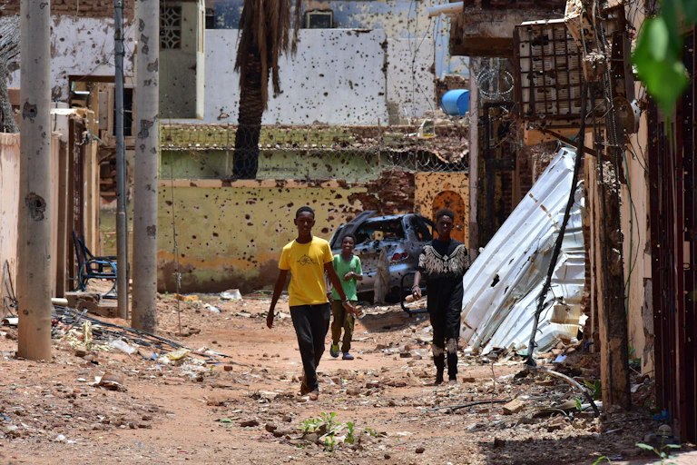 Young people on a war-damaged street in Omdurman, Sudan, August 2024.