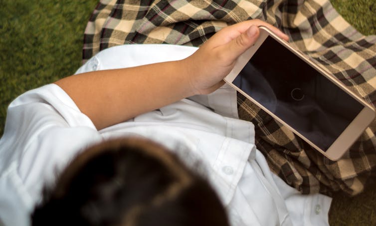 A youth holding a cellphone.