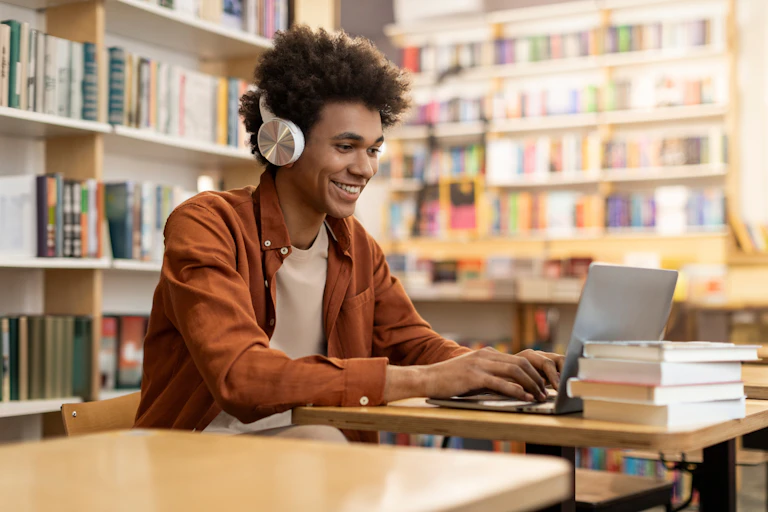Man working at laptop in library