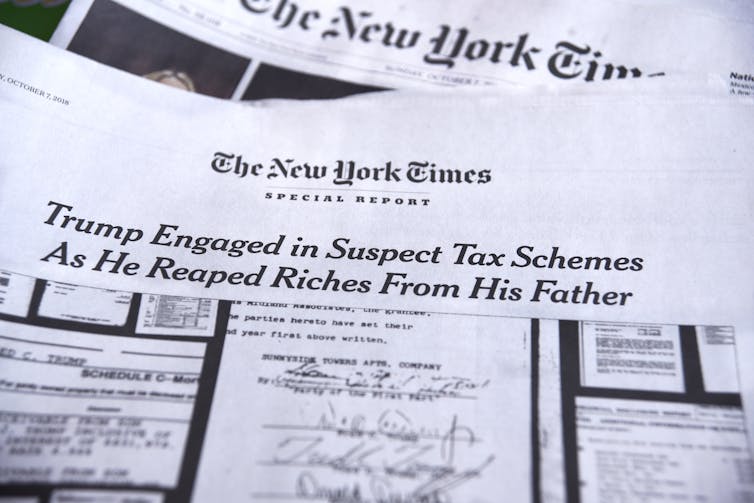 A New York Times edition with the headline 'Trump Engaged in Suspect Tax Schemes as He Reaped Riches From His Father.'