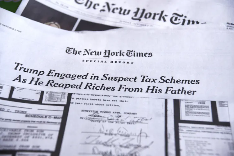 A New York Times edition with the headline 'Trump Engaged in Suspect Tax Schemes as He Reaped Riches From His Father.'